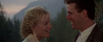 Movie still from “Roxanne” (1987), directed by Fred Schepisi – A man and a woman smiling at each other; Close Up shot, Over the shoulder angle