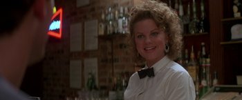 Movie still from “Roxanne” (1987), directed by Fred Schepisi – A woman wearing a white shirt and a bow tie; Close Up shot, Low angle