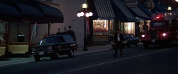 Movie still from “Roxanne” (1987), directed by Fred Schepisi – A man walking down a street at night; Wide shot, High angle