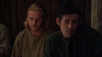 Movie still from “Royal Deceit” (1994), directed by Gabriel Axel – Two men sitting next to each other in the dark; Medium shot, Low angle