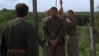 Movie still from “Royal Deceit” (1994), directed by Gabriel Axel – A group of men standing next to each other on a field; Medium shot, Over the shoulder angle
