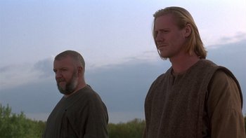 Movie still from “Royal Deceit” (1994), directed by Gabriel Axel – A couple of men standing next to each other; Medium shot, Low angle