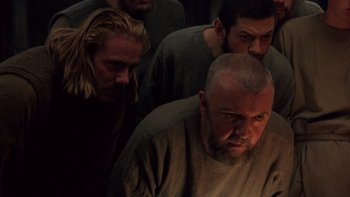 Movie still from “Royal Deceit” (1994), directed by Gabriel Axel – A group of men standing next to each other in a dark room; Close Up shot, High angle