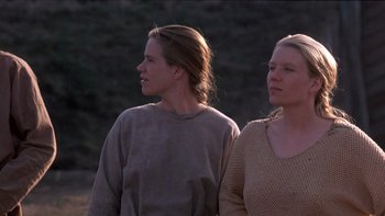 Movie still from “Royal Deceit” (1994), directed by Gabriel Axel – Two women standing next to each other on a field; Medium shot, Low angle