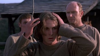 Movie still from “Royal Deceit” (1994), directed by Gabriel Axel – A man with his hands on his head and two other men; Close Up shot, Over the shoulder angle