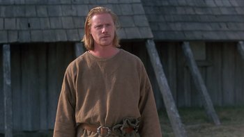 Movie still from “Royal Deceit” (1994), directed by Gabriel Axel – A man with long blonde hair wearing a brown shirt; Medium shot, Low angle