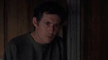 Movie still from “Royal Deceit” (1994), directed by Gabriel Axel – A person wearing a sweater near a wall; Close Up shot, Over the shoulder angle