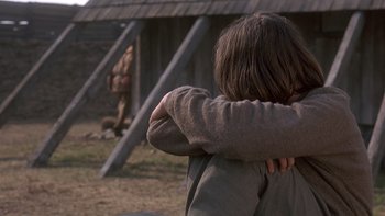 Movie still from “Royal Deceit” (1994), directed by Gabriel Axel – A young boy holding his arms around his shoulders; Close Up shot, Over the shoulder angle