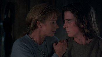 Movie still from “Royal Deceit” (1994), directed by Gabriel Axel – A woman and a young man looking at one another; Close Up shot, Over the shoulder angle