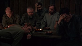 Movie still from “Royal Deceit” (1994), directed by Gabriel Axel – A group of men sitting around a table with candles; Medium shot, High angle