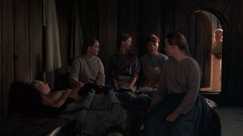 Movie still from “Royal Deceit” (1994), directed by Gabriel Axel – A group of people sitting on a couch in a room; Wide shot, High angle