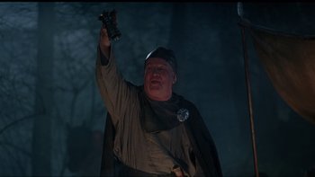 Movie still from “Royal Deceit” (1994), directed by Gabriel Axel – A man holding up a camera while wearing a medieval outfit; Medium shot, Low angle