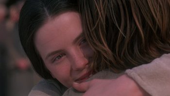 Movie still from “Royal Deceit” (1994), directed by Gabriel Axel – A person hugging another person; Close Up shot, Over the shoulder angle