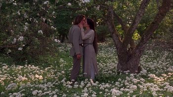 Movie still from “Royal Deceit” (1994), directed by Gabriel Axel – A man and a woman standing next to each other in a field; Medium shot, High angle