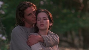 Movie still from “Royal Deceit” (1994), directed by Gabriel Axel – A man and a woman embracing each other in a forest; Close Up shot, Low angle