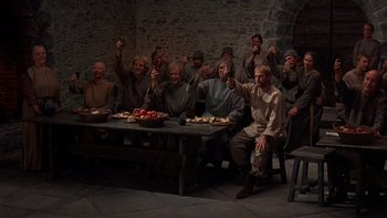 Movie still from “Royal Deceit” (1994), directed by Gabriel Axel – A group of people sitting around a table; Wide shot, High angle