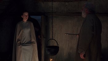 Movie still from “Royal Deceit” (1994), directed by Gabriel Axel – Two people standing next to each other near a pot; Medium shot, Low angle