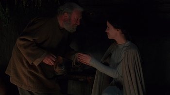Movie still from “Royal Deceit” (1994), directed by Gabriel Axel – An old man and a young woman are holding hands; Medium shot, High angle