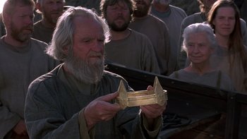 Movie still from “Royal Deceit” (1994), directed by Gabriel Axel – An old man holding a golden object in front of a group of people; Close Up shot, Low angle