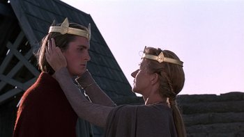 Movie still from “Royal Deceit” (1994), directed by Gabriel Axel – A woman putting a crown on a man's head; Close Up shot, Low angle