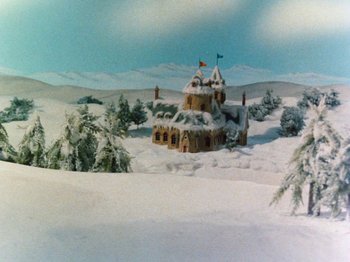 Movie still from “Rudolph and Frosty's Christmas in July” (1979), directed by Jules Bass – A snowy landscape with a castle in the middle of it; Extreme Wide shot, High angle