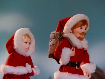 Movie still from “Rudolph and Frosty's Christmas in July” (1979), directed by Jules Bass – A doll wearing a santa claus suit; Medium shot, Low angle