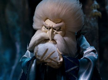Movie still from “Rudolph and Frosty's Christmas in July” (1979), directed by Jules Bass – A doll with a white wig and a white beard; Close Up shot, Low angle