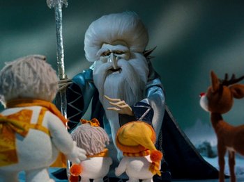 Movie still from “Rudolph and Frosty's Christmas in July” (1979), directed by Jules Bass – A group of stuffed animals that are standing in a room; Medium shot, Low angle