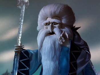 Movie still from “Rudolph and Frosty's Christmas in July” (1979), directed by Jules Bass – A doll with a long white beard; Medium shot, Low angle