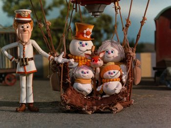 Movie still from “Rudolph and Frosty's Christmas in July” (1979), directed by Jules Bass – A lot of toys in the air balloon; Wide shot, Low angle