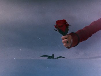 Movie still from “Rudolph and Frosty's Christmas in July” (1979), directed by Jules Bass – A hand holding a red rose in front of a bird; Extreme Close Up shot, Overhead angle