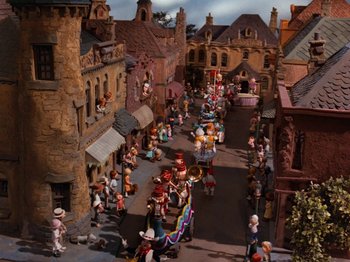 Movie still from “Rudolph and Frosty's Christmas in July” (1979), directed by Jules Bass – A group of people are walking down the street; Extreme Wide shot, High angle