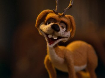 Movie still from “Rudolph and Frosty's Christmas in July” (1979), directed by Jules Bass – A stuffed dog with a branch hanging from its head; Extreme Close Up shot, High angle
