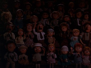 Movie still from “Rudolph and Frosty's Christmas in July” (1979), directed by Jules Bass – A bunch of dolls that are sitting in a room; Wide shot, High angle