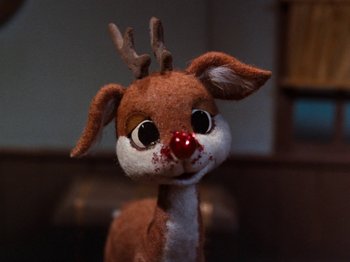 Movie still from “Rudolph and Frosty's Christmas in July” (1979), directed by Jules Bass – A stuffed toy reindeer with a red nose; Close Up shot, High angle