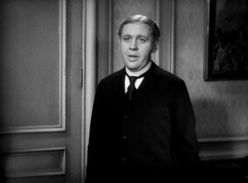 Movie still from “Ruggles of Red Gap” (1935), directed by Leo McCarey – A black and white photo of a man in a suit and tie; Medium shot, Over the shoulder angle