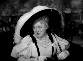 Movie still from “Ruggles of Red Gap” (1935), directed by Leo McCarey – An older woman wearing a hat and holding an umbrella; Close Up shot, High angle