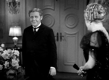 Movie still from “Ruggles of Red Gap” (1935), directed by Leo McCarey – A black and white photo of a man and a woman; Medium shot, Over the shoulder angle