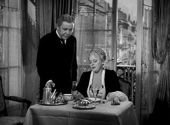 Movie still from “Ruggles of Red Gap” (1935), directed by Leo McCarey – A man and a woman sitting at a dinner table; Medium shot, High angle
