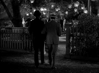 Movie still from “Ruggles of Red Gap” (1935), directed by Leo McCarey – A couple of men walking down a path at night; Wide shot, High angle