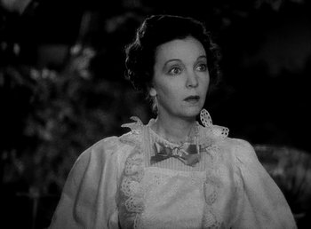 Movie still from “Ruggles of Red Gap” (1935), directed by Leo McCarey – An old photo of a woman wearing a bow tie; Close Up shot, High angle