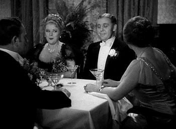 Movie still from “Ruggles of Red Gap” (1935), directed by Leo McCarey – A group of people sitting at a table with drinks; Medium shot, High angle