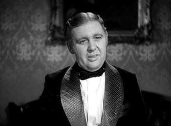 Movie still from “Ruggles of Red Gap” (1935), directed by Leo McCarey – An older man wearing a tuxedo in front of an ornate wall; Close Up shot, Over the shoulder angle