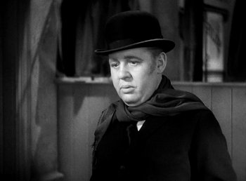 Movie still from “Ruggles of Red Gap” (1935), directed by Leo McCarey – A man wearing a black hat and a black scarf; Close Up shot, Low angle