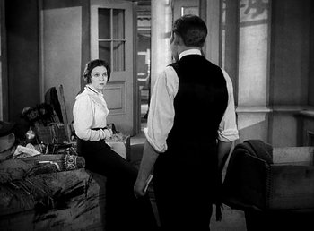 Movie still from “Ruggles of Red Gap” (1935), directed by Leo McCarey – A man and a woman are standing in front of a door; Medium shot, High angle