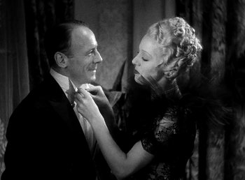 Movie still from “Ruggles of Red Gap” (1935), directed by Leo McCarey – A man and a woman in formal wear are looking at each other; Medium shot, Low angle