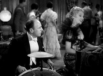 Movie still from “Ruggles of Red Gap” (1935), directed by Leo McCarey – A man and a woman in a black and white photo; Medium shot, Over the shoulder angle