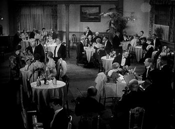 Movie still from “Ruggles of Red Gap” (1935), directed by Leo McCarey – A black and white photo of people sitting at tables in a restaurant; Extreme Wide shot, High angle