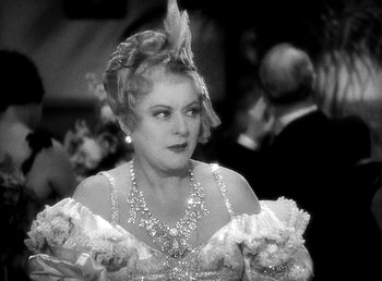 Movie still from “Ruggles of Red Gap” (1935), directed by Leo McCarey – An old photo of a woman in a dress; Close Up shot, Over the shoulder angle