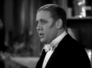 Movie still from “Ruggles of Red Gap” (1935), directed by Leo McCarey – A black and white photo of a man in a tuxedo; Close Up shot, Low angle